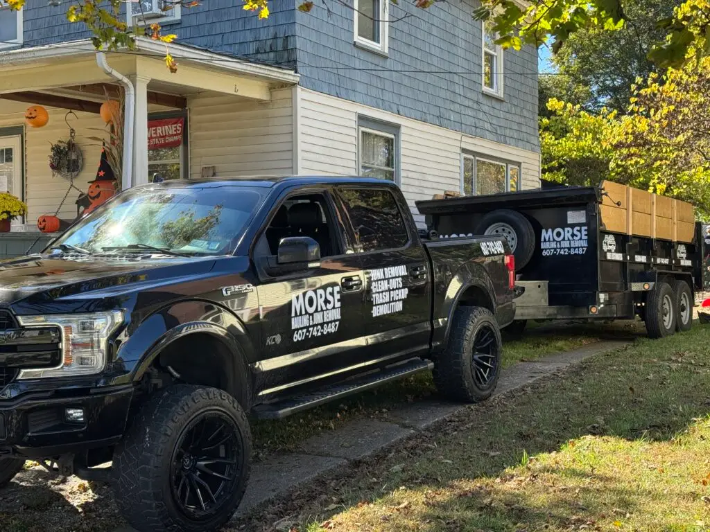 Morse Hauling & Junk Removal truck and trailer on a residential junk removal job in Elmira, NY