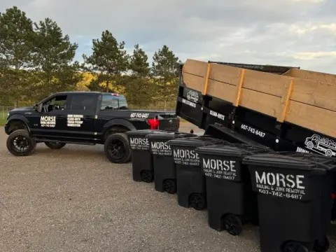 Commercial junk removal in Elmira, NY with Morse Hauling & Junk Removal truck, trailer, and bins onsite