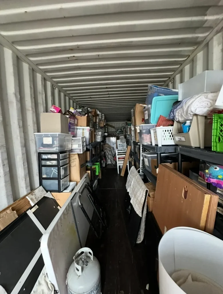 Box truck packed with boxes, storage bins, and household items during a residential junk removal cleanout in Elmira, NY.